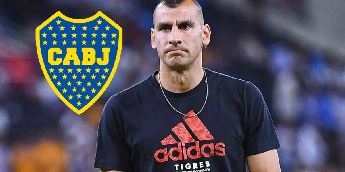 Nahuel Guzmán junto al escudo de Boca Juniors.